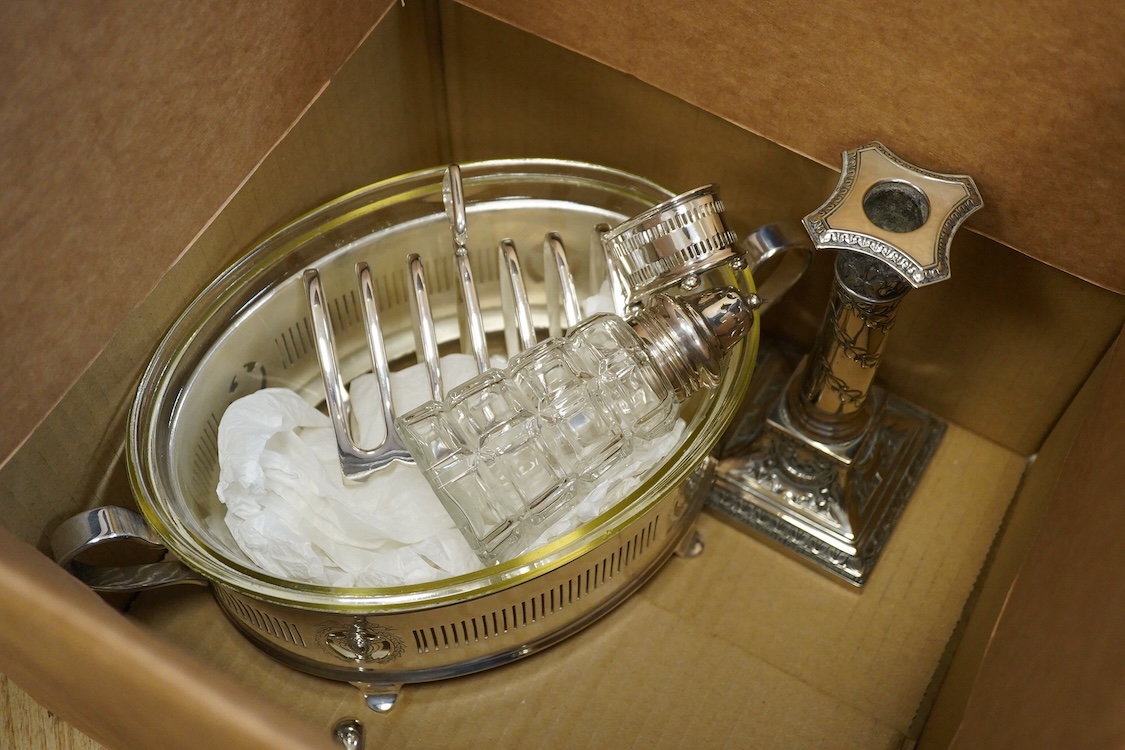 Assorted plated wares including a pair of candlesticks and a casserole dish.